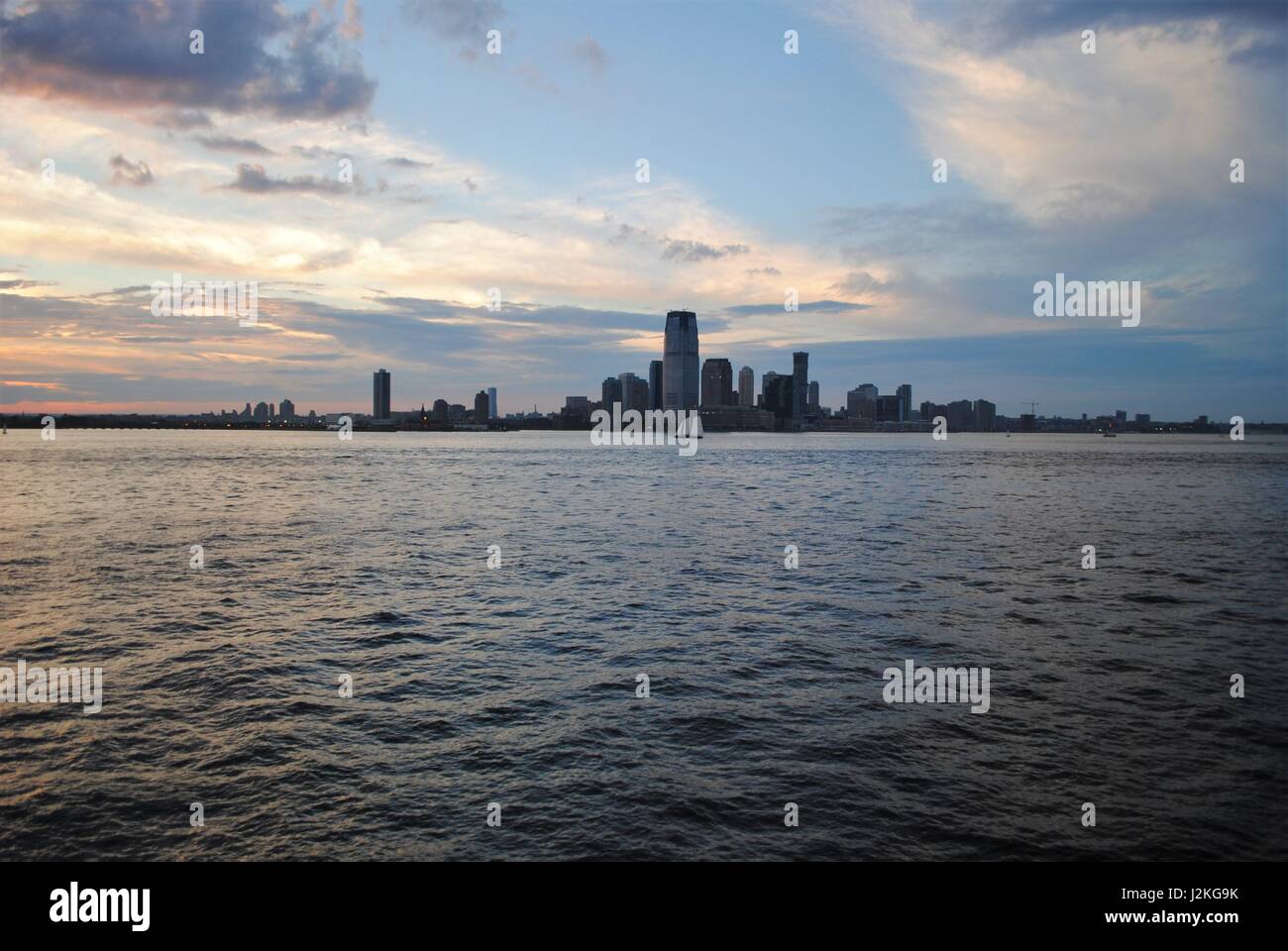 A  sailboat passing by Lower Manhattan in the Upper Bay, New York, the United States Stock Photo