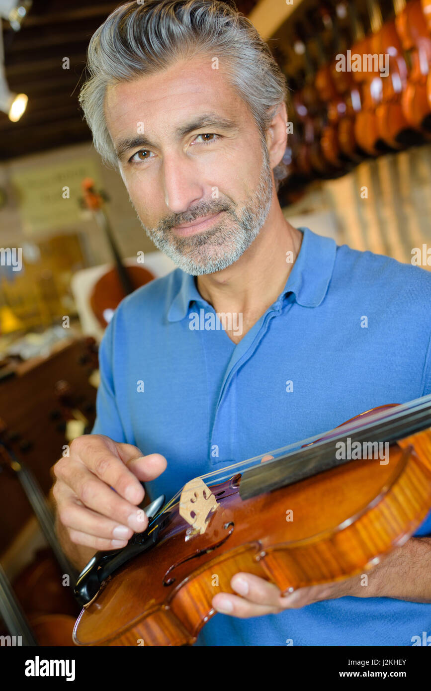 Man holding violin Stock Photo Alamy