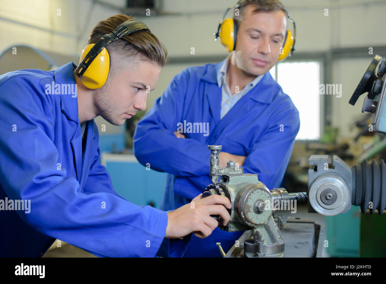 Jobe Using Machine working with machine Stock Photo - Alamy