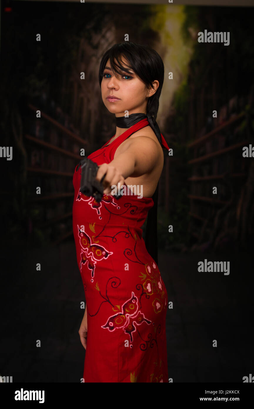 Powerful Woman Holding Gun Action Movie Style resident evil cosplay costume Stock Photo