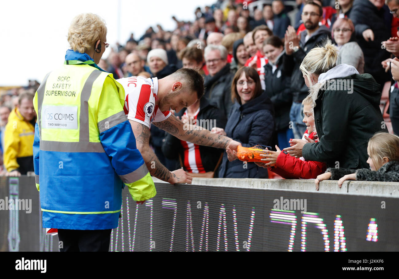 Stoke City's Marko Arnautovic gives his boots to a young fan after the  Premier League match at the bet365 Stadium, Stoke Stock Photo - Alamy