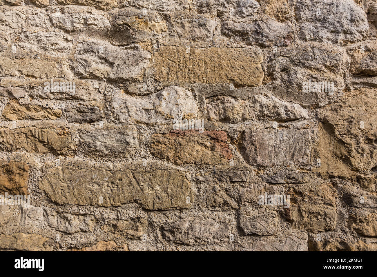 close up of weathered stone wall showing natural stone texture, good