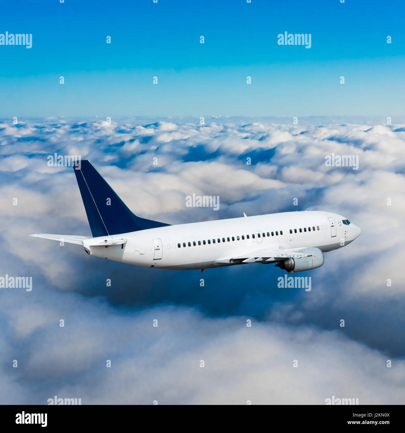 Passenger airplane flying above dramatic clouds Stock Photo - Alamy
