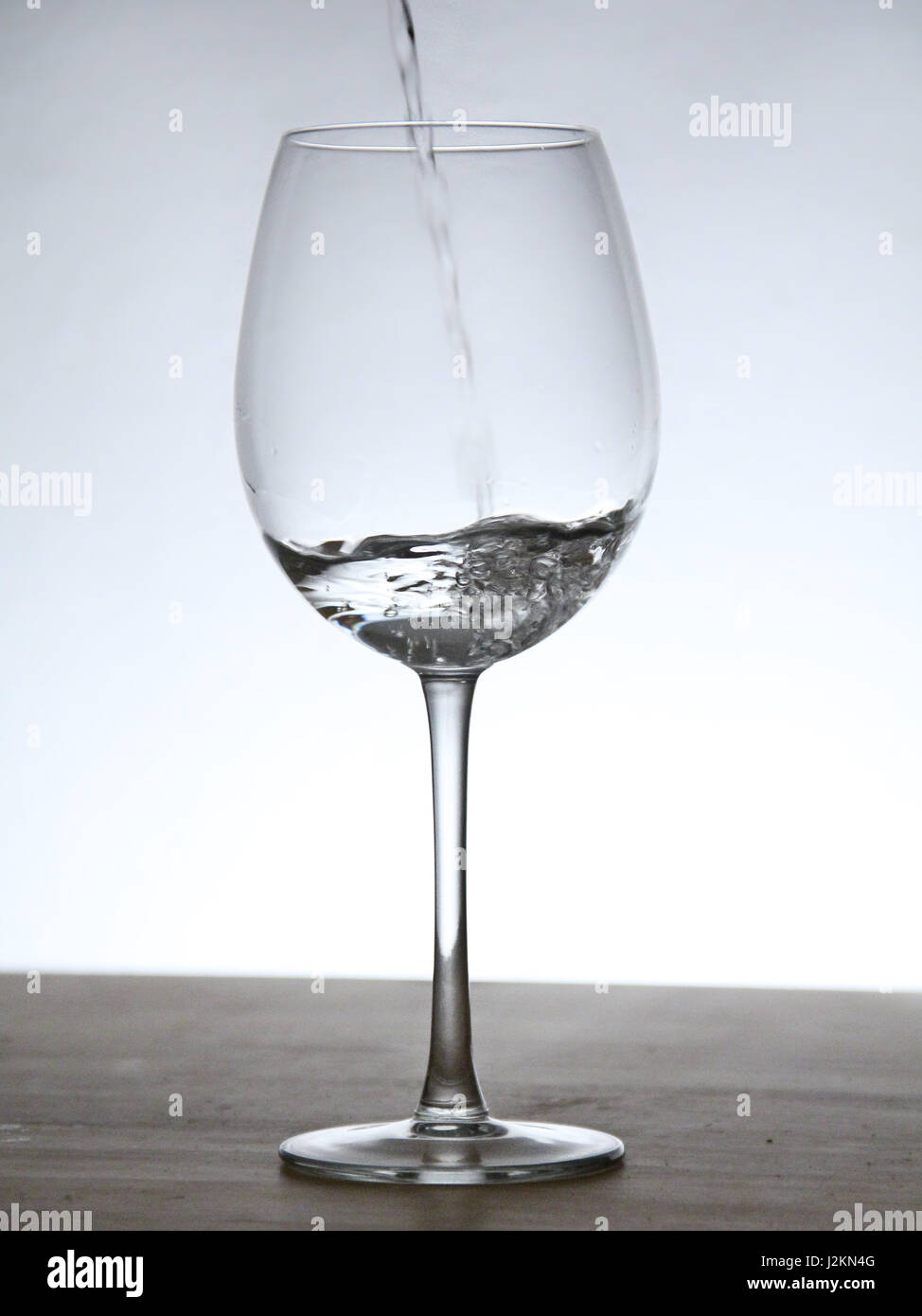 Still of a glass with background light. Simple water glass. Simple wine ...