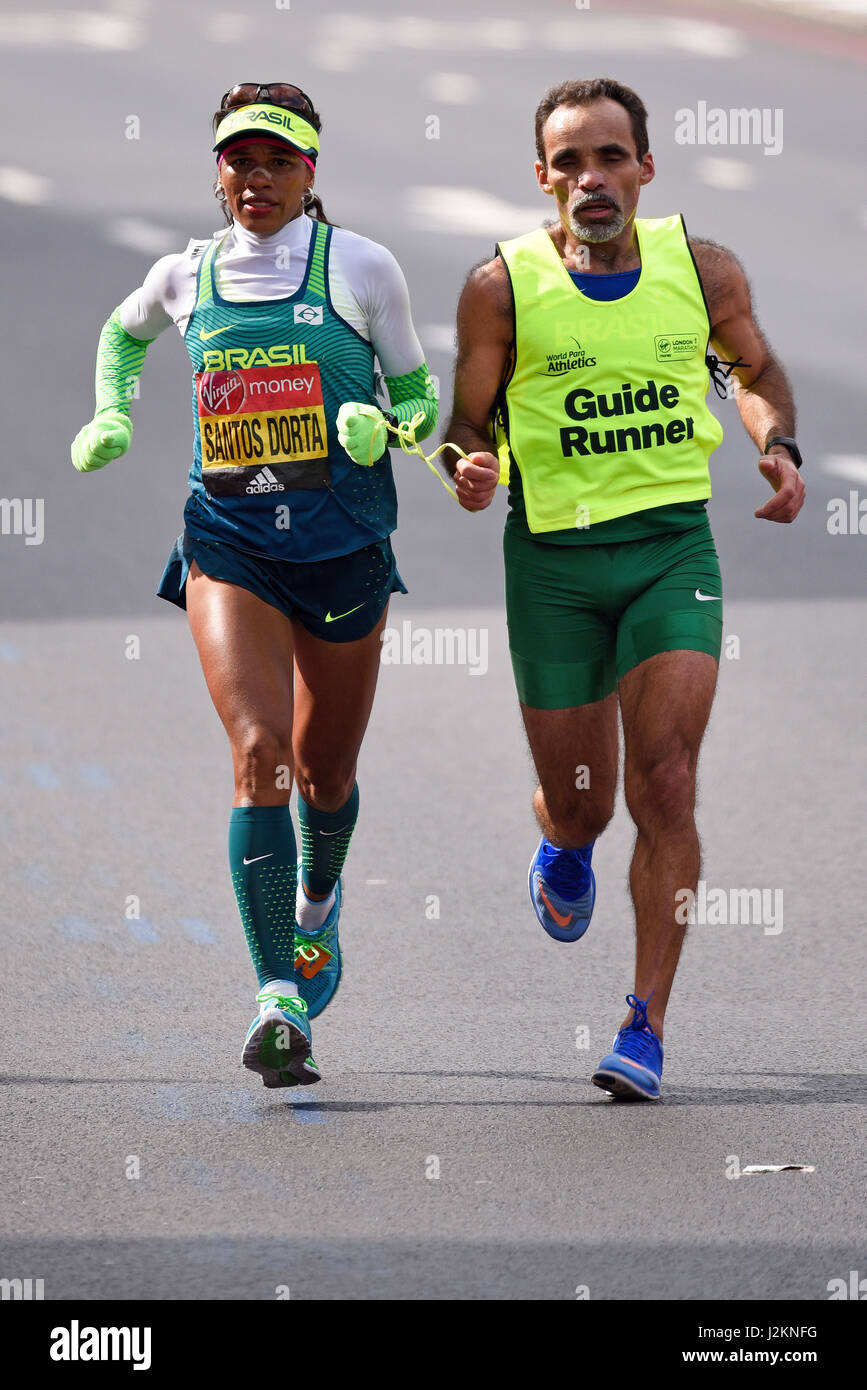 Edeneusa De Jesus Santos Dorta of Brazil and her guide runner running in the 2017 London Marathon Stock Photo