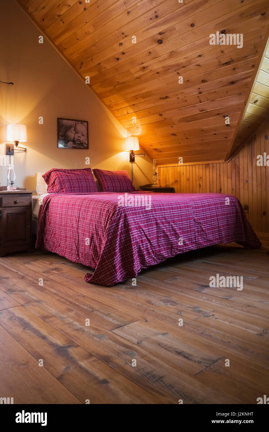 King size bed in master bedroom on the upstairs floor inside a cottage