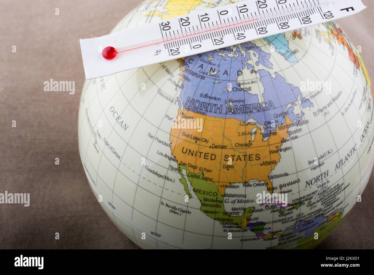 Thermometer placed on a little model globe Stock Photo Alamy