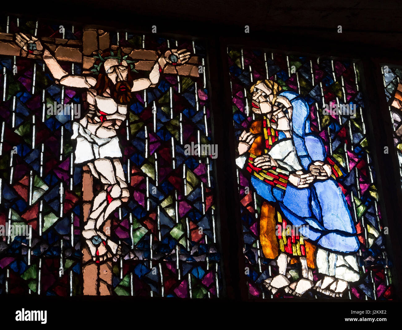 Stained glass window by Henri Martin-Granel representing the crucifixion. Notre dame de Royan church. Royan, France, Europe. Stock Photo