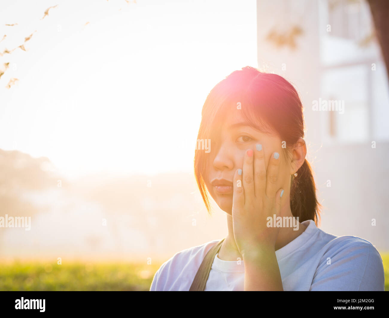 Beautiful Young Asian - Chinese Woman Holding Cheek, Have A Toothace Stock Photo