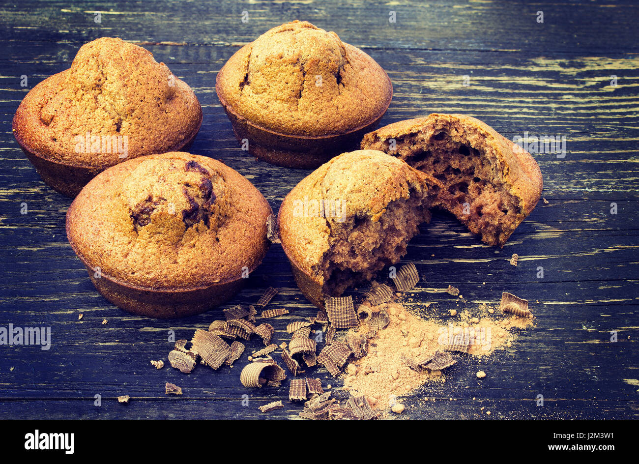 Fresh chocolate muffins on a dark wooden background.Toning effect Stock Photo