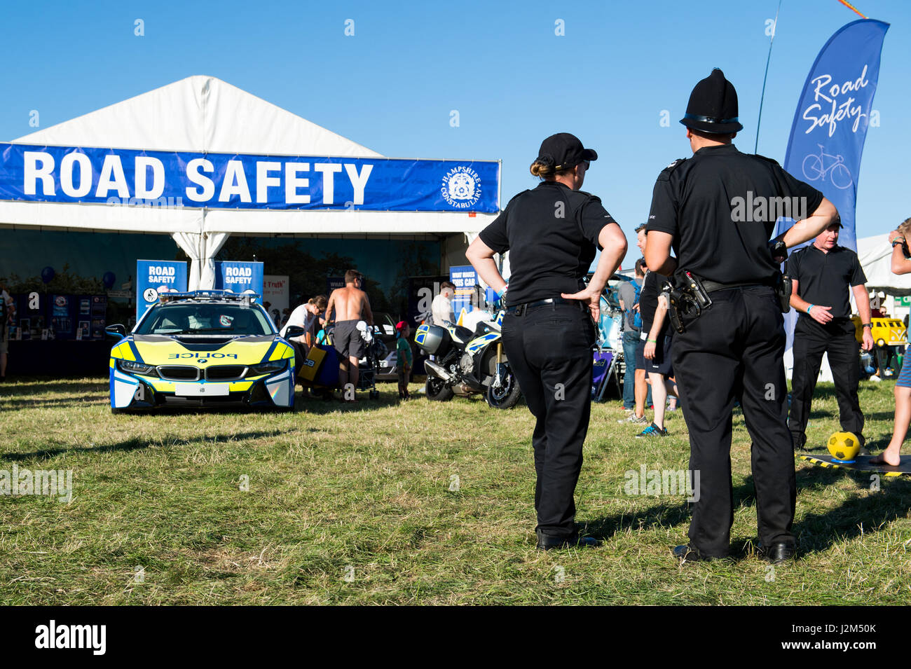 Laverstoke Park Farm, Overton, Basingstoke, Hampshire, United Kingdom. 26 August 2016. Hampshire Constabulary Road Safety Police stand with the police BMW I8 hybrid supercar at Radio 2 breakfast show DJ, Chris Evans' Car Fest South 2016 - Car, Food, Family and Music Festival for BBC Children in Need. © Will Bailey / Alamy Stock Photo
