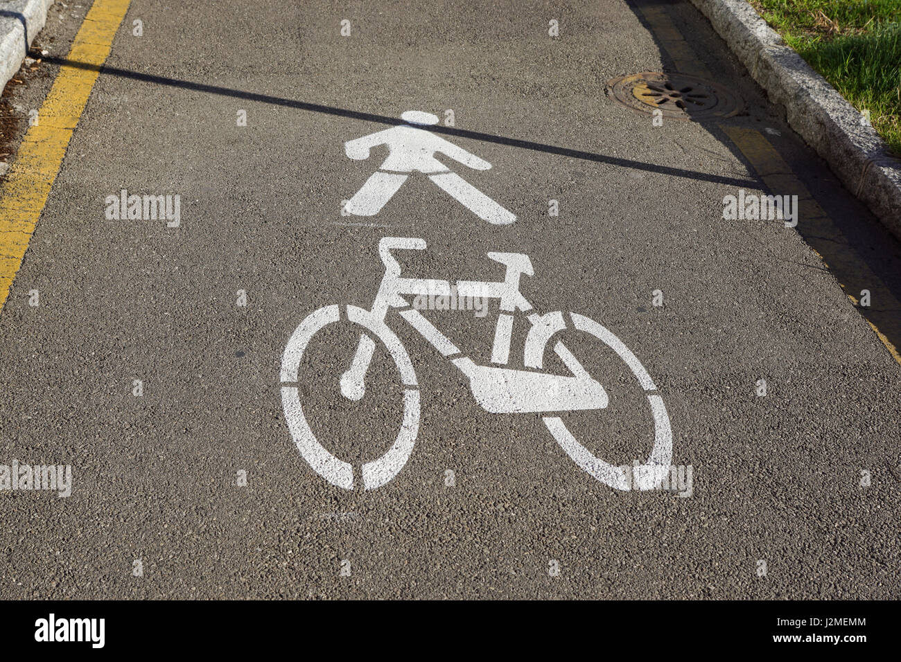 White painted bicycle way sign on asphalt in park. Stock Photo