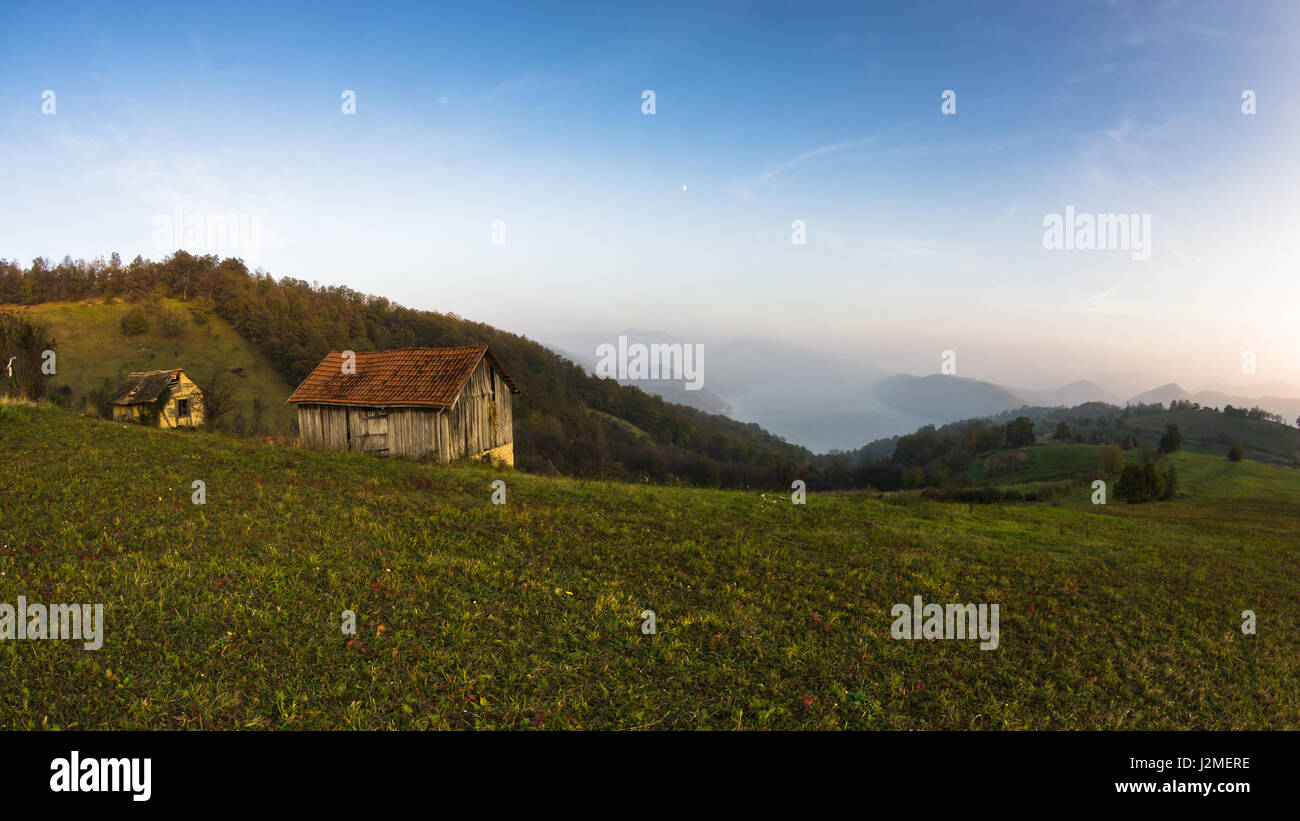 Autumn sunset at hillsides and meadow with mist over Danube river in Serbia Stock Photo