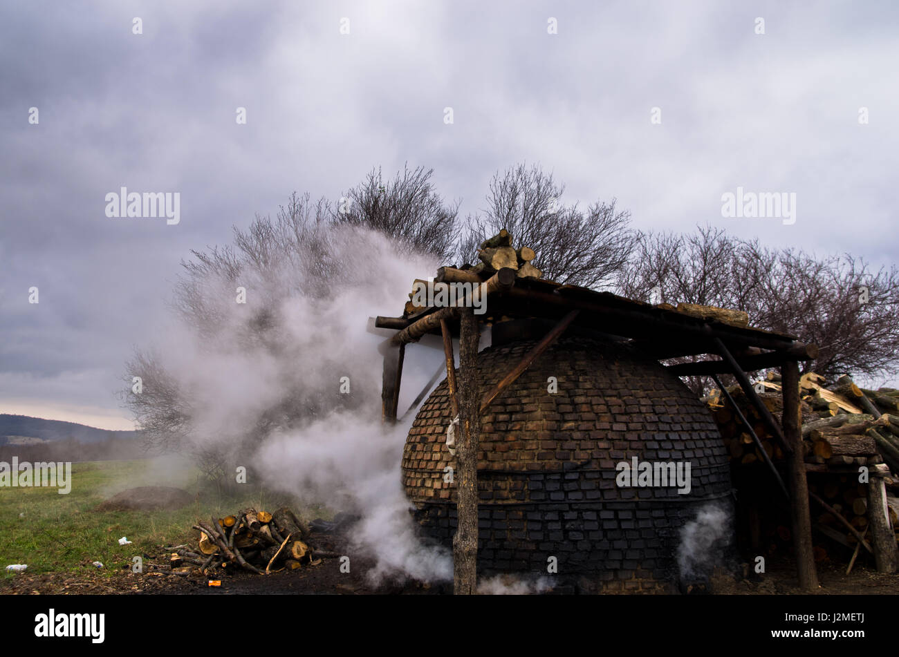 Traditional coal making process on a cloudy autumn day in east Serbia Stock Photo