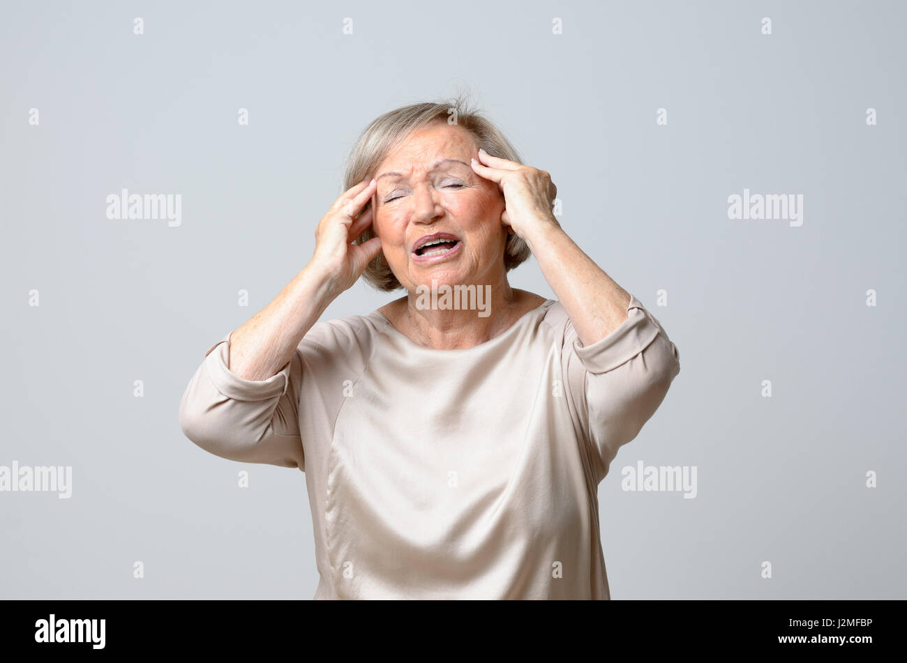 Woman portrait hands on temples hi-res stock photography and images - Alamy