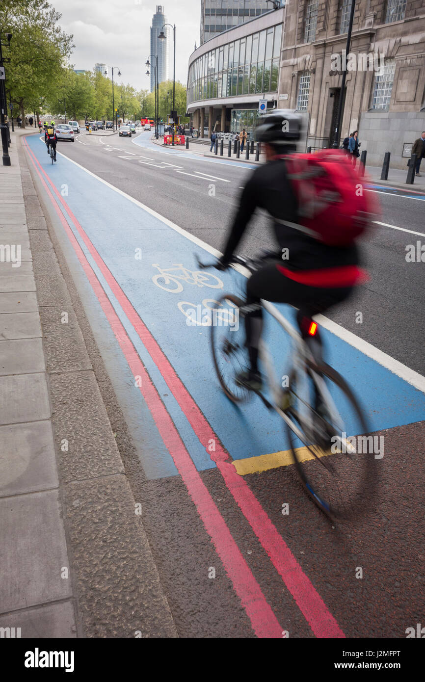 Cyclists following the route of Cycle Superhighway 8 on Milbank, Westminster, London, UK Stock Photo