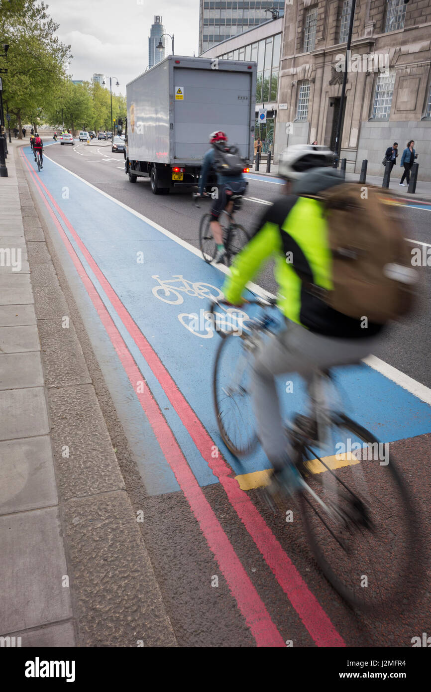 Cyclists following the route of Cycle Superhighway 8 on Milbank, Westminster, London, UK Stock Photo