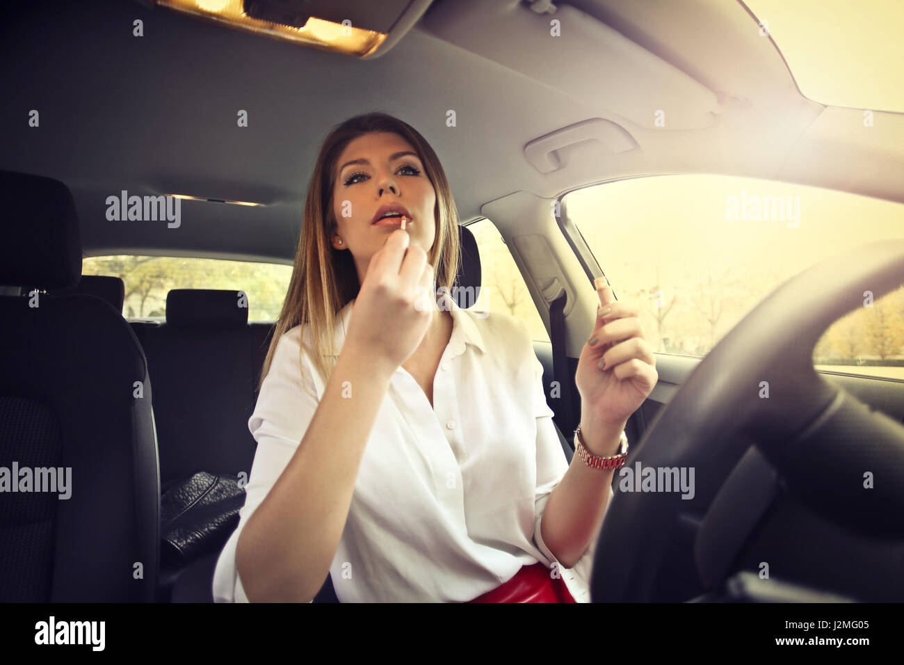 Woman doing her makeup in car Stock Photo Alamy
