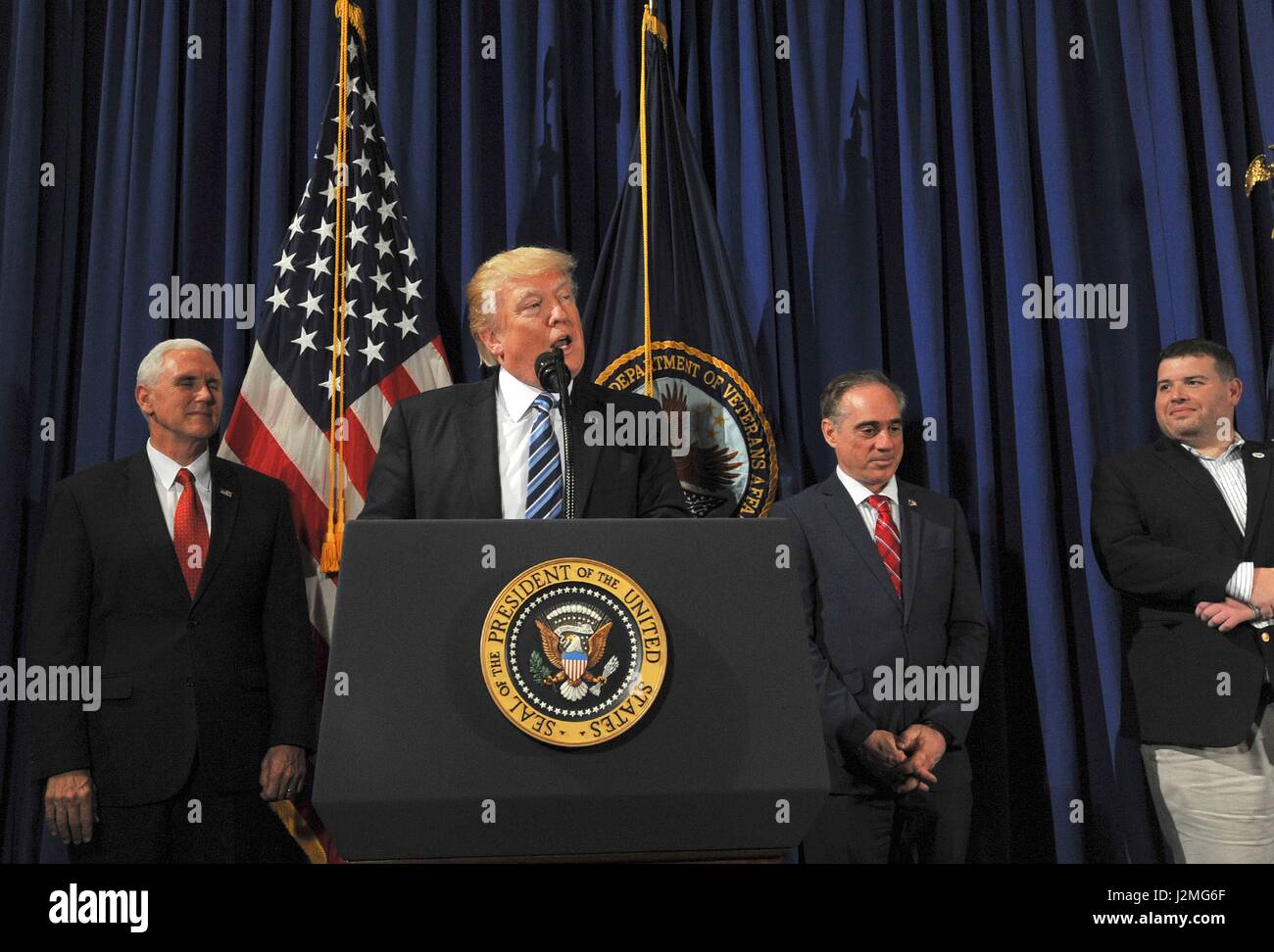 U.S President Donald Trump along with Vice President Mike Pence, left, and Secretary of Veterans Affairs, Dr. David Shulkin, right, thanks Veterans for their service before signing the Improving Accountability and Whistleblower Protection Executive Order during an event at the Veterans Administration April 27, 2017 in Washington, D.C. Stock Photo