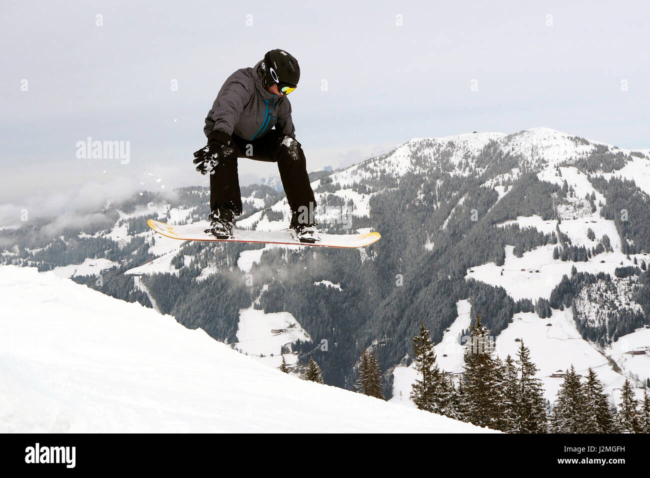 Snowboarder mid jump Stock Photo