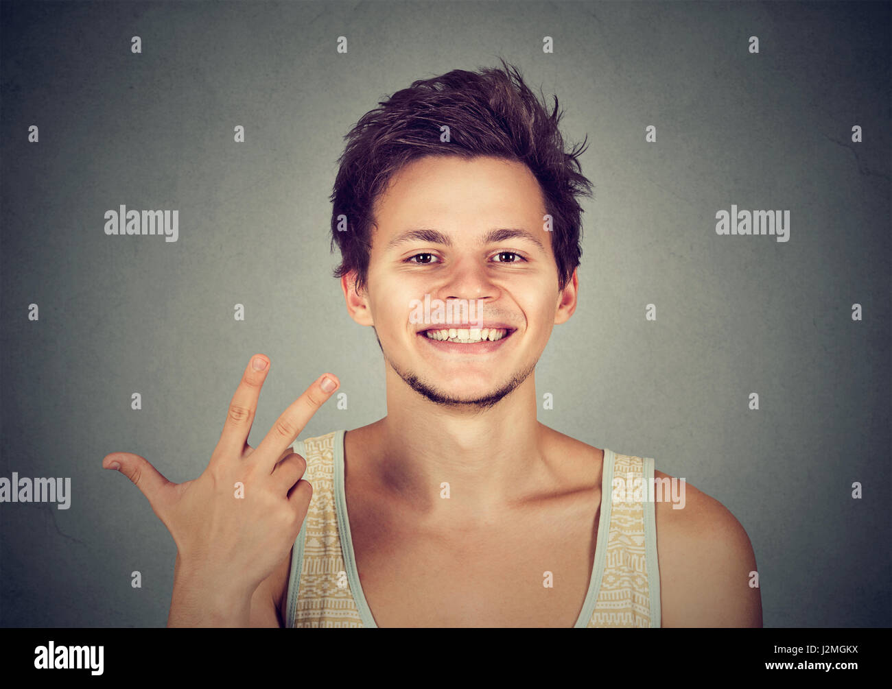 man giving a three fingers sign gesture with hand isolated on gray