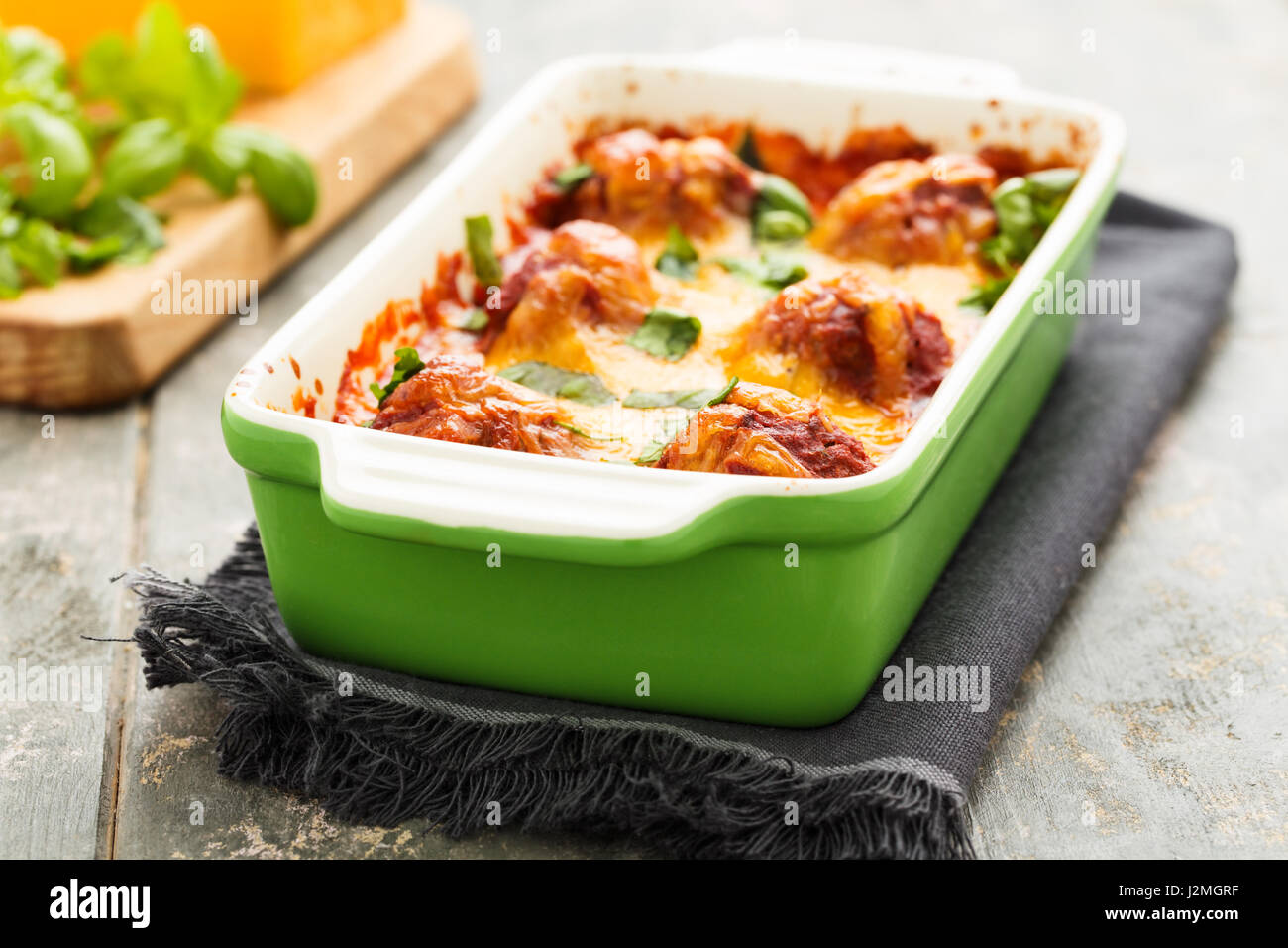 Homemade meatballs au gratin with mozzarella, parmesan and cheddar