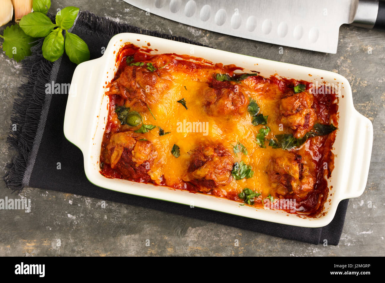 Homemade meatballs au gratin with mozzarella, parmesan and cheddar