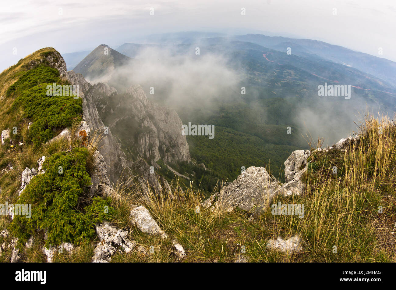 Rocks and cliffs in clouds trekking path near Trem peak at Suva Planina mountain in East Serbia Stock Photo