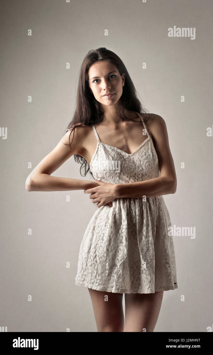 Brunette woman in pretty white dress Stock Photo
