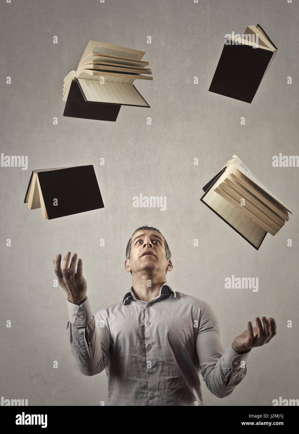 Man throwing books Stock Photo Alamy