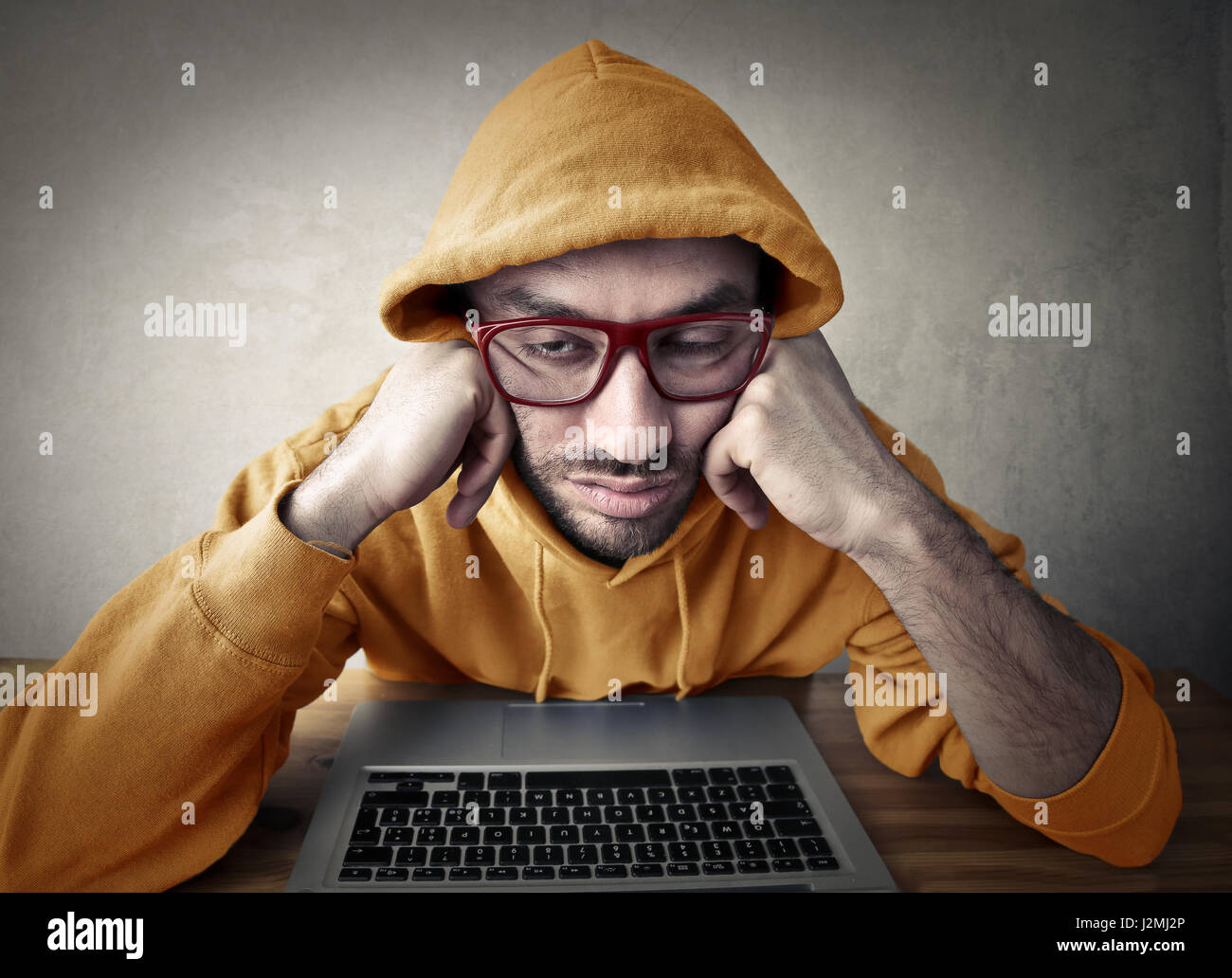 Tired man in front of laptop Stock Photo - Alamy