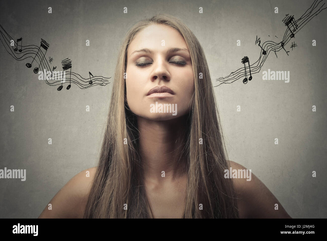 Woman with melody coming out of her ears Stock Photo