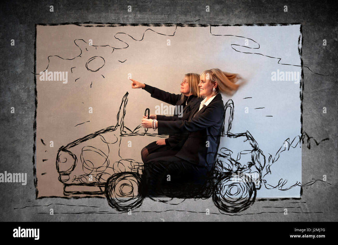 2 women sitting on drawn car Stock Photo