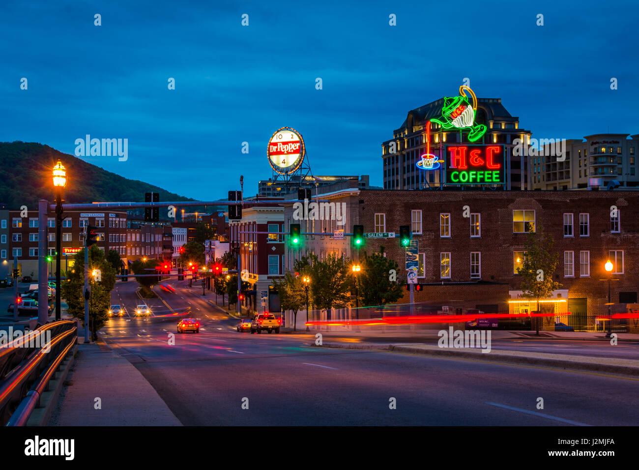Neon signs and buildings along Williamson Road at night in downtown