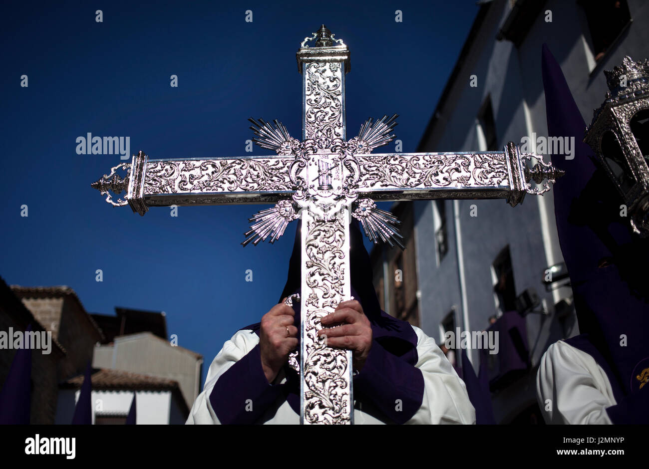 A man holds a silver cross during Easter Week celebrations in Baeza, Jaen Province, Andalusia, Spain Stock Photo