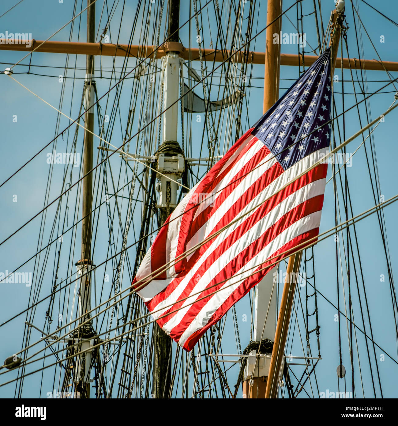 A flag on the back of a sailing ship in southern California. Stock Photo