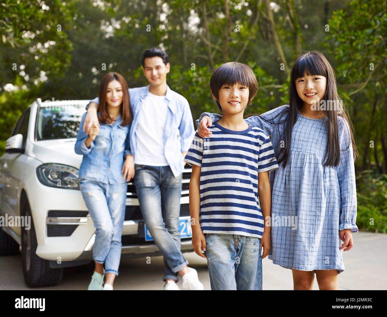 asian family with two children taking a photo during travel by car. Stock Photo
