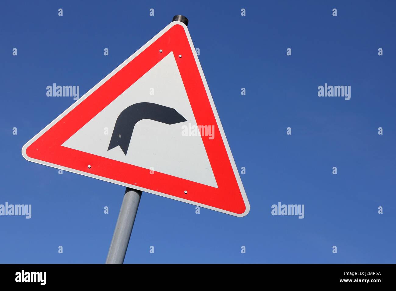 German road sign: dangerous curve Stock Photo