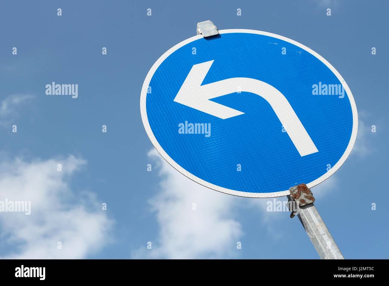 German road sign: left turn Stock Photo - Alamy