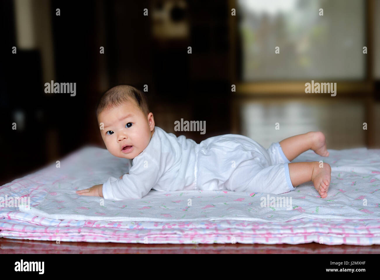 Newborn baby lying down on the mattress Stock Photo Alamy