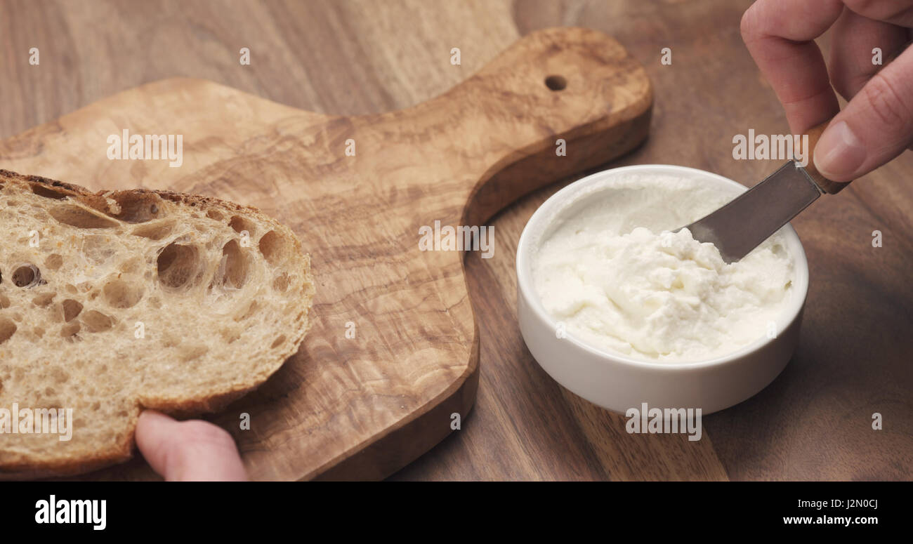 taking ricotta cheese to spread on bread, 4k photo Stock Photo Alamy
