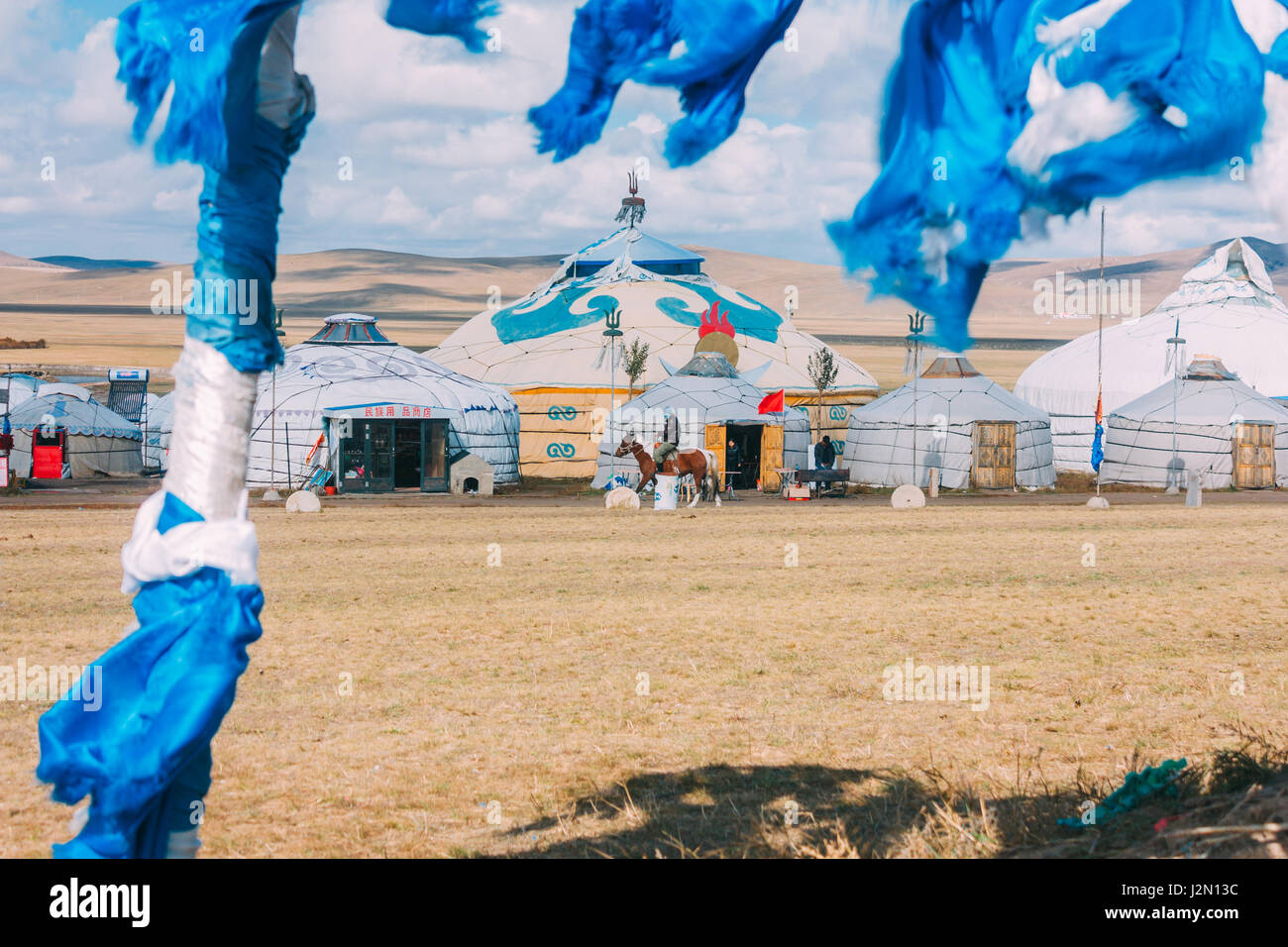 20140924 Inner mogolia,China white and blue obo and aobao in a front ,group of yurts in mongolia ,mongol totem, in grassland with blue sky,horizontal Stock Photo
