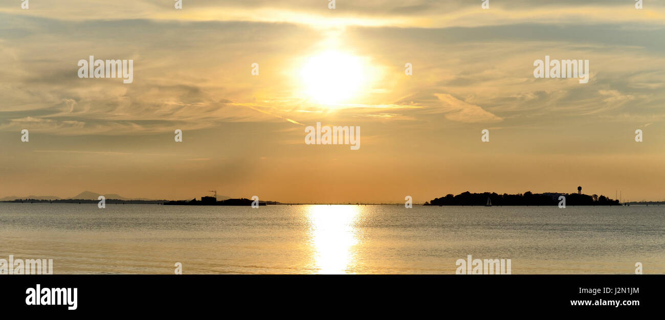romantic view of the lagoon of Venice seen from the shore, at sunset ...