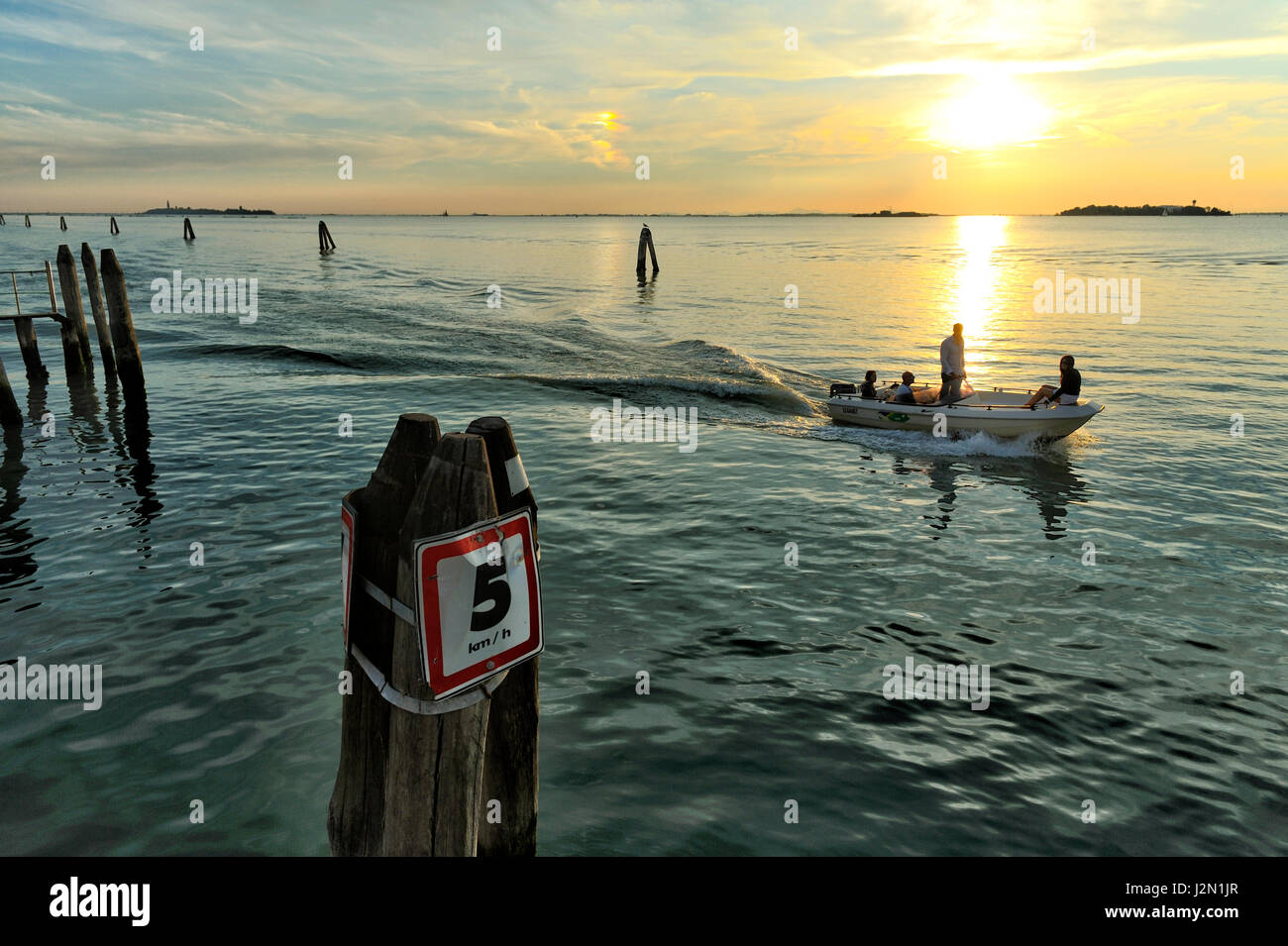 romantic view of the lagoon of Venice seen from the shore, at sunset ...