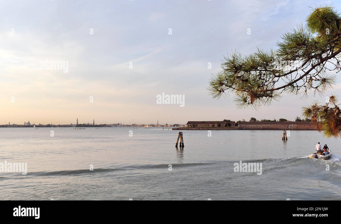 romantic view of the lagoon of Venice seen from the shore, at sunset ...