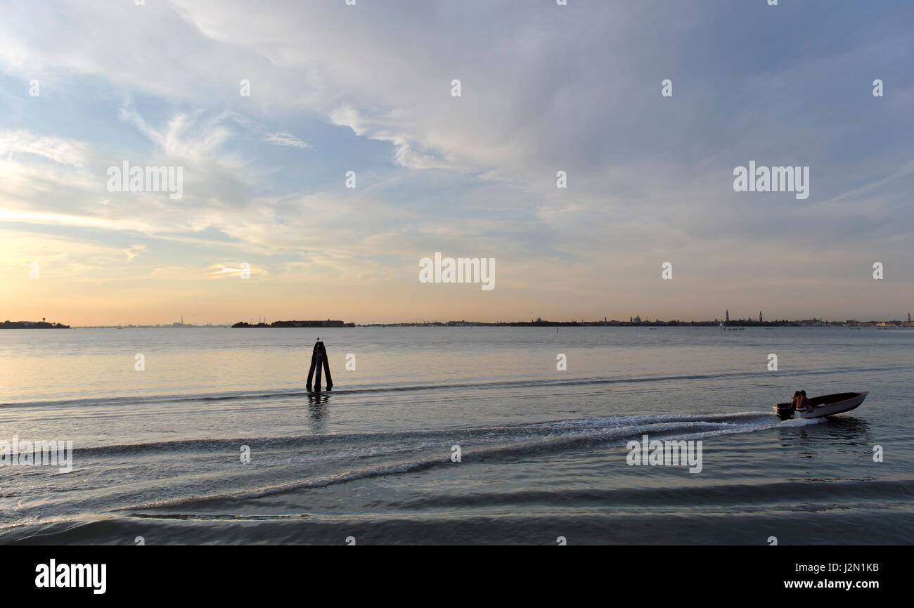 romantic view of the lagoon of Venice seen from the shore, at sunset ...