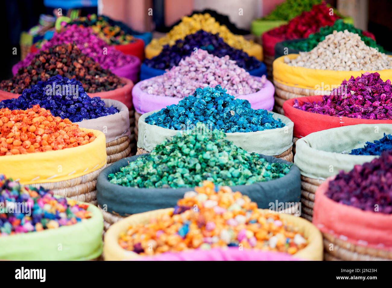 Dried flowers with vibrant colours on sale at a market vendor in the medina of Marrakesh in Morocco. Stock Photo