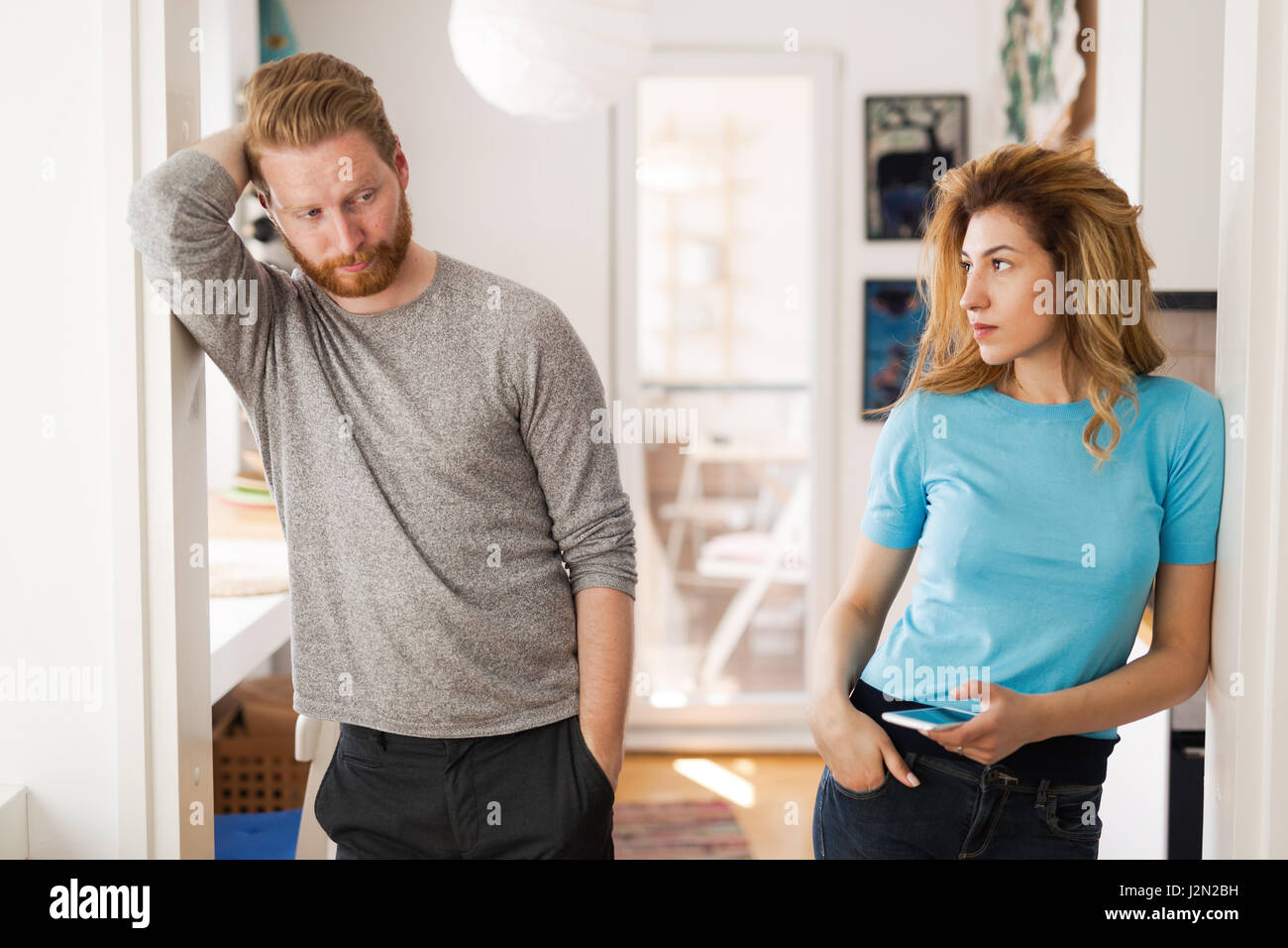 Couple having arguments at home and being frustrated with relationship Stock Photo