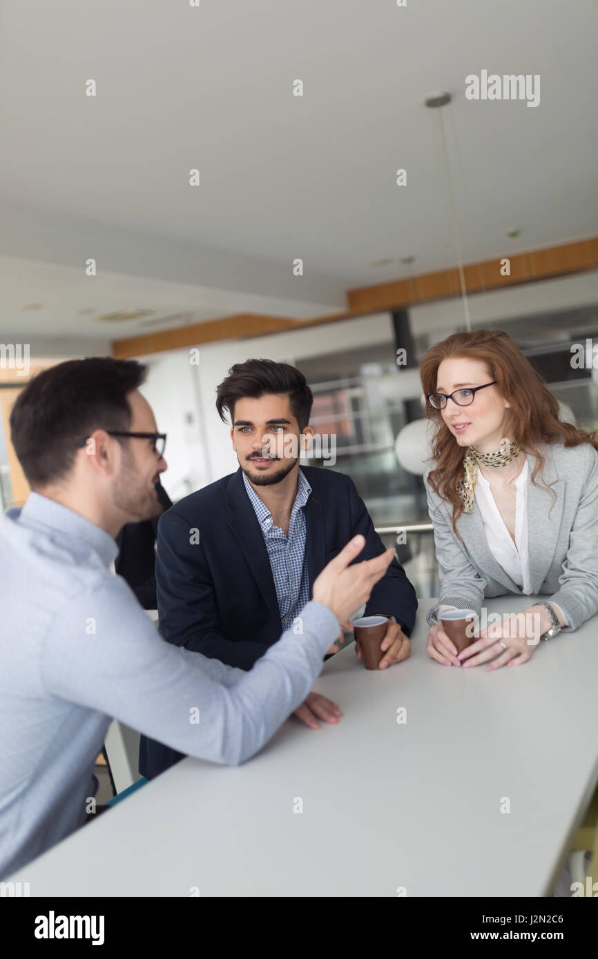 Professionals business colleagues collaborating and discussing project plans Stock Photo
