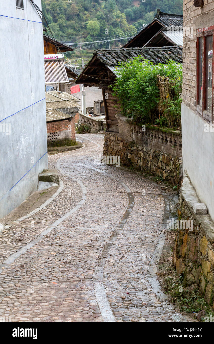 Matang, a Gejia Village in Guizhou, China.  Village Street Descending Hill. Stock Photo